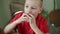 Small beautiful boy with big eyes eating an apple appetizing.