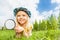 Small beautiful girl with magnifier laying alone