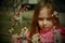 A small, beautiful girl in pink clothes walking in the Park near a flowering tree