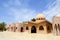 Small beautiful neat old ancient stone clay Arab Islamic Muslim houses with round domes in the desert with palm trees in a tropica