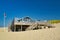 Small beautiful wooden beach pavilion called `Paal 19` on a summer day on island Texel in Netherlands