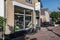 Small bicycle shop building showing shop window, entrance and sign