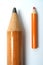 Small and big pencils laying beside in parallel