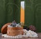 Small birch bark casket surrounded by pearls on background of candle