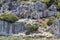 Small black goats cadge on historical Lycian ruins near Mediterranean sea