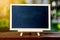 Small blackboard placed on a wooden table The back is a green tree. For educational illustration