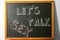 Small blackboard with written phrase `LET`S TALK SEX`