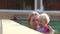 Small Blonde Child Swim with Mother