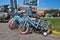 Small blue bicycles with training wheels for children at bike renting station for tourists on island Texel