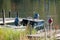 Small blue boat docked at wooded dock