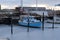 Small blue boat in a frozen harbour