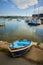 Small blue dinghy in Bembridge Harbour on the Isle of Wight, vertical