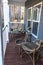 Small blue gray mobile home front porch with rattan chairs