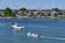 A small blue outboard power boat in the calm water of Westport River at Westport Point, MA