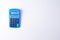Small blue plastic calculator on a white background. Isolate. Copy space. Flat lay