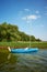 Small blue sailboat moored by reeds, Drawsko Lake, Poland