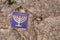 Small blue tile with menorah symbol embedded in the pavement of the former Jewish quarter, Toledo, Spain