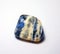 Small blue and white sodalite, a trumpeted mineral on a white background.