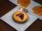 Small Blueberry cake with a single flickering candle and a Happy Birthday decorative sign