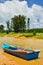 Small boat at beach witch blue sky and clouds