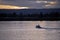 Small boat in calm waters of river evening at sunset