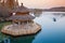 Small boat and Chinese wooden gazebo on the coast