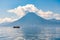 Small boat cruises past San Pedro Volcano, Lake Atitlan, Guatemala