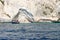 A small boat is docked at one of the many beaches along the rocky coast of Zakynthos, Greece