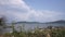 A small boat full of people travels along a peaceful river in Uganda.