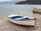 A small boat in the harbor of Valun on a cloudy day in spring