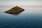 A small boat heading to the Ballycotton lighthouse in Ireland at sunset