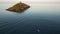 A small boat heading to the Ballycotton lighthouse in Ireland at sunset