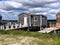 Small boat houses sit on pilings at the edge of the harbor.