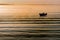 A small boat isolated and shot as a silhouette on a calm Venice Lagoon