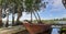 a small boat leaning on the shore of Lake Seran