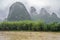 Small boat on the Li River valley while passing Xingpingzhen fishing village