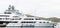 Small Boat by Massive Yacht by Cruise Ship