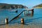 Small boat near old rusty dock at sunny morning, Porto Koufo