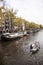 Small boat passing houseboats in brouwersgracht