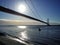 Small boat passing under Humber Bridge