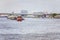 Small boat pulling commercial barge on chao phraya river