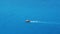 Small boat quickly floating on the calm water surface and leaving a trail on the sea. 4k video