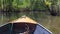 Small boat sailing on mangroves green water