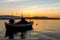 Small boat on a sea at sunset.