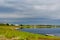 A small boat stands on the shore on the Northern Yakut river vilyu near the village of ulus Suntar with houses and a communication