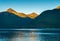 Small boat and sunrise lon calm early morning in Taiya Inlet, Skagway, Alaska.