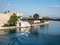 Small boat in Taranto, Italy under Ponte Girevole di San Francesco di Paola bridge near Castello Aragonese fortress