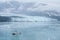 Small boat with tourists watching Hubbard Glacier. Alaska