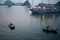 Small boats aproaching the cruisse ships to sell their goods to the tourists. Late afternoon, lights on