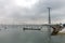 Small boats in the bay of Cadiz on a cloudy day with a huge communications tower in the background